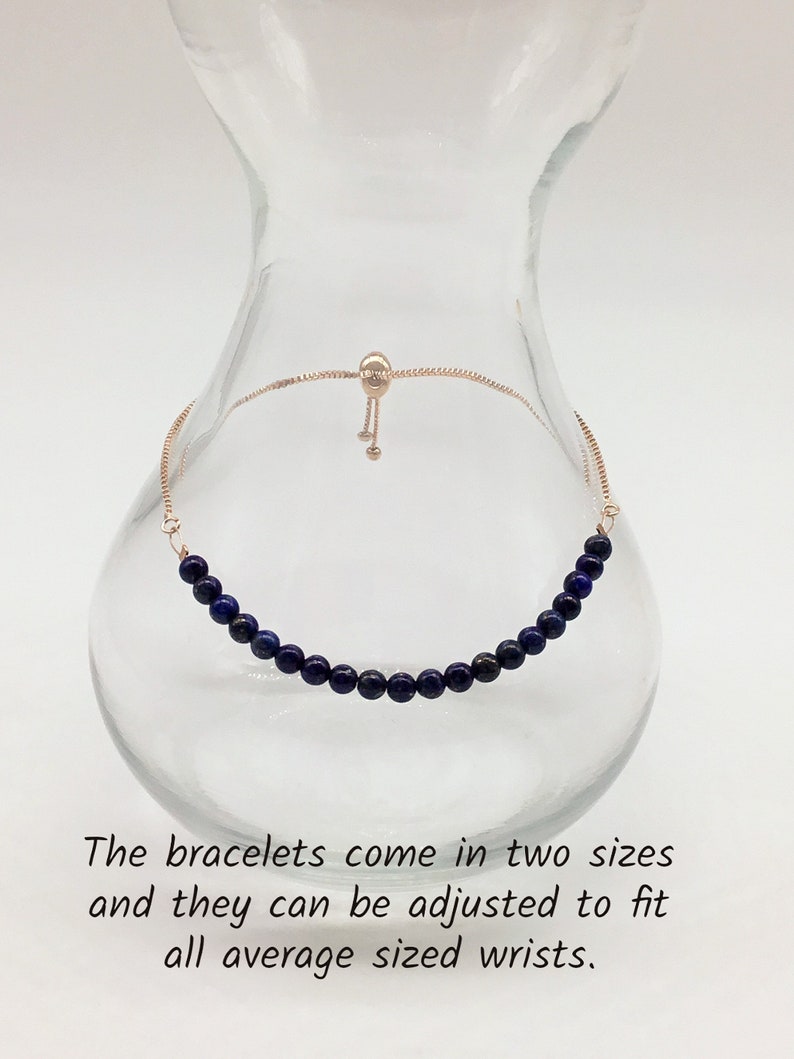 May include: A delicate bracelet made with dark blue lapis lazuli beads and a gold chain with a sliding clasp. The bracelet is adjustable to fit most wrist sizes.