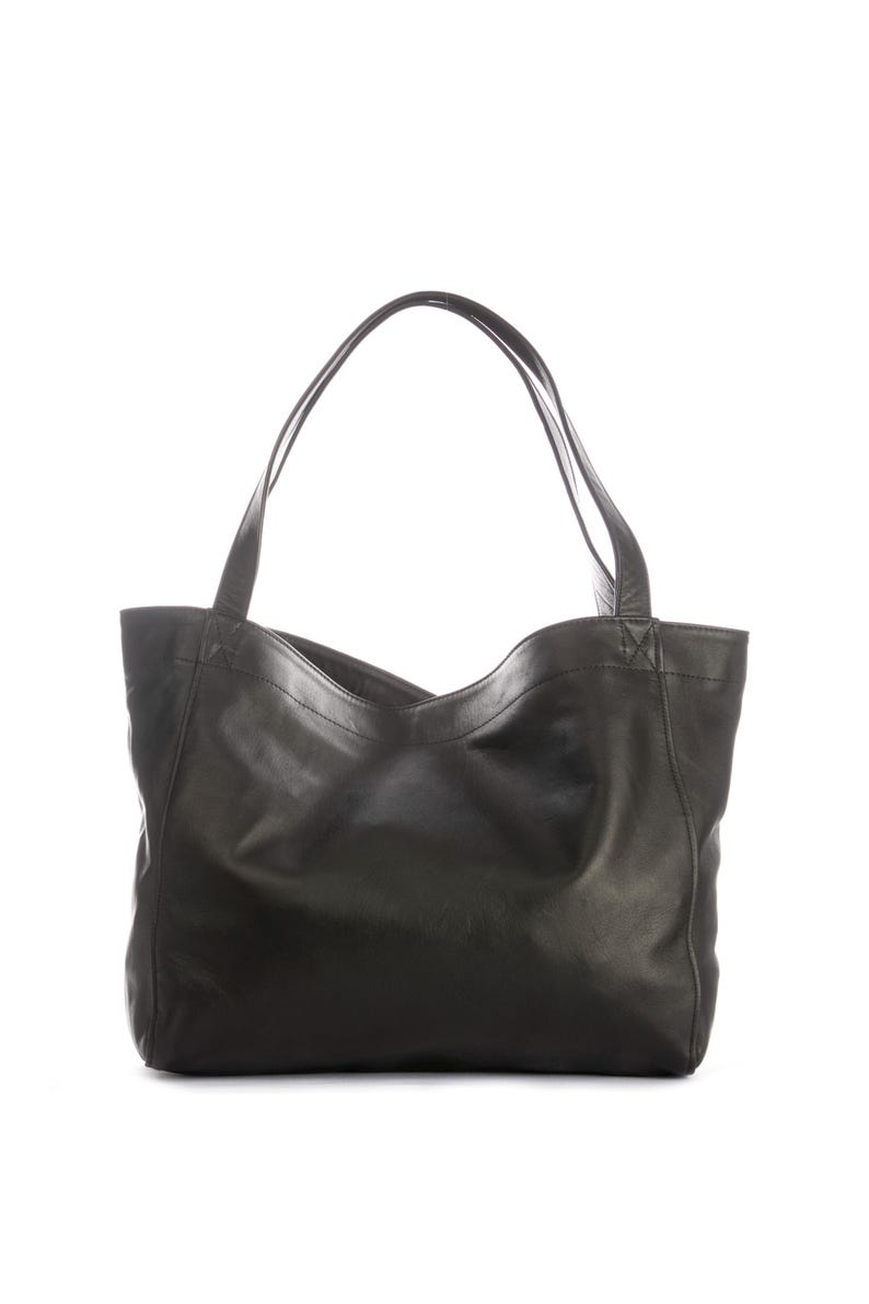 May include: Black leather tote bag with two shoulder straps. The bag has a simple, open top design and a spacious interior. The leather appears to be smooth and has a slight sheen. The bag is suitable for everyday use.