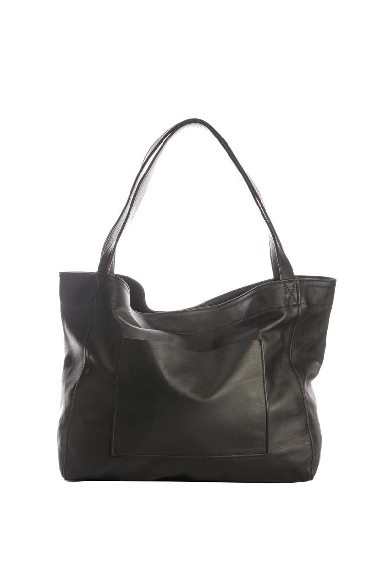 May include: Black leather tote bag with two long shoulder straps and a large exterior pocket. The bag has a simple, minimalist design and is made of a smooth, matte leather. The bag is suitable for everyday use.