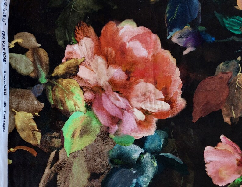 May include: A black background with a watercolor floral print featuring a large pink and red rose with green leaves. The print is called "Gertrude Rose" and is by Designers Guild.