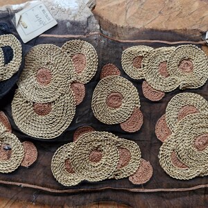 May include: A black sheer fabric with gold and brown embroidered circles. The fabric has a vintage look and feel.