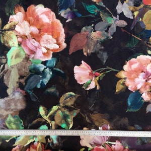 May include: Black fabric with a watercolor floral print featuring pink, orange, and green roses. The fabric has a dark background with a subtle sheen.