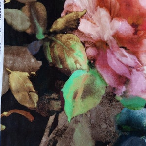 May include: A watercolor-style floral print fabric featuring large pink and red roses with green leaves on a black background. The fabric has the text "JUDE ROSE." and "&copy; Designers Guild Ltd. 2022 Printed in England" printed on the side.