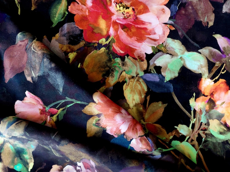 May include: A black fabric with a floral print featuring large pink, red, and orange flowers with green leaves.