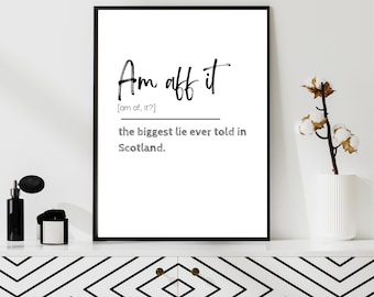 May include: A framed black and white print with the text "Am aff it" and the definition "the biggest lie ever told in Scotland." The print is displayed on a white cabinet with a black and white geometric design.