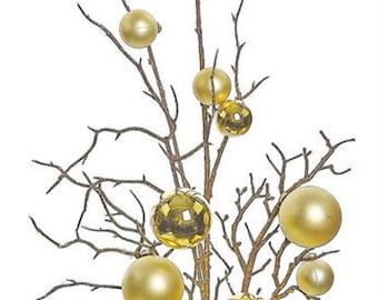 May include: A gold twig spray with multiple gold ornaments. The twig spray is perfect for adding a touch of sparkle to any holiday decor.