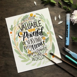 May include: A watercolor painting with a green and yellow floral design. The painting features the text "Never doubt that you are valuable and powerful & deserving of every chance & opportunity in the world."