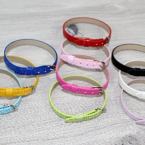 May include: Assortment of colorful leather watch bands with silver buckles. The bands are in various colors, including blue, yellow, light blue, green, pink, red, black, and white.