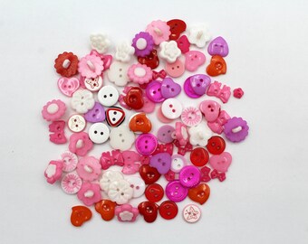 Mixed pink buttons for Craft and Sewing. Assorted buttons various sizes and designs.