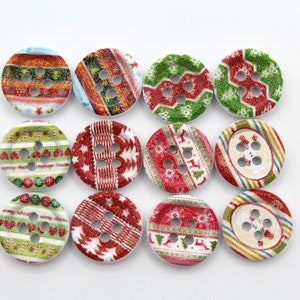 May include: Twelve round decorative buttons with festive Christmas patterns. The buttons feature various designs in red, green, white, and blue, including stripes, snowflakes, and geometric shapes. Each button has four holes for sewing.