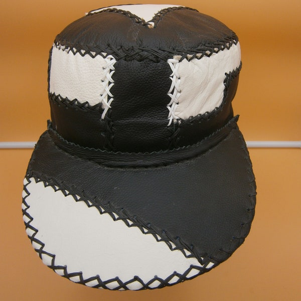 Distinctive medium to large black and white leather patchwork cap