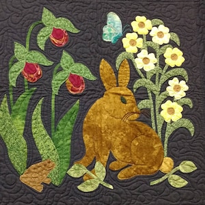 May include: A brown rabbit sits in a field of yellow flowers and green leaves. A blue butterfly is flying above the flowers. There are also pink flowers in the background.