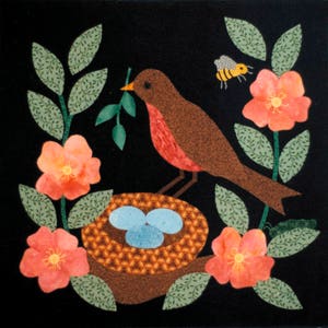 May include: A brown and red robin bird perches on a branch with green leaves and holds a green twig in its beak. The bird is near a brown nest with three blue eggs inside. There are pink flowers with yellow centers on the branches. A yellow and black bee flies above the flowers.