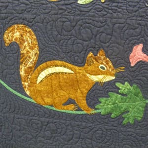 May include: A brown and white squirrel with a bushy tail is perched on a green vine with a pink flower. The squirrel is sitting on a dark blue background with a swirling pattern.