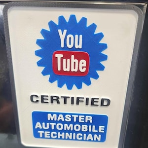 May include: A white and blue YouTube Certified Master Automobile Technician badge. The YouTube logo is in a blue gear shape with a red rectangle and the word "Tube". The text "CERTIFIED" and "MASTER AUTOMOBILE TECHNICIAN" are also visible.
