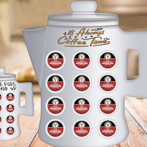 May include: Two white ceramic coffee pot shaped containers with the text "It's Always Coffee Time" and "The Best Part of Waking Up" on them. Each container has 16 round coffee pods with the text "Peppermint Bark" on them.