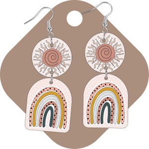 May include: A pair of dangle earrings featuring a pink and white rainbow with yellow, orange, and brown accents and a pink sun with a spiral design.