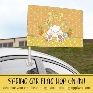 May include: A car flag with a yellow background featuring a bunny's backside, carrots, and Easter eggs. The text "Hop on In" is displayed in a playful font. The flag is attached to a car window with a white plastic clip. The bottom of the flag has a yellow border with white dashes.