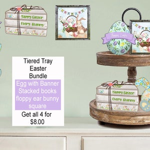 May include: A tiered tray Easter bundle with four items: a blue and green egg with a banner that says "Happy Easter", a stack of books with a ribbon and the text "Happy Easter Every Bunny", a blue and green floppy ear bunny, and a square frame with a bunny and the text "Happy Easter".