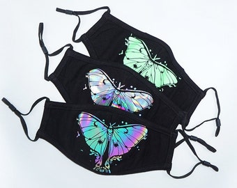 May include: Three black face masks with iridescent butterfly designs. The butterflies are in shades of green, blue, and purple.