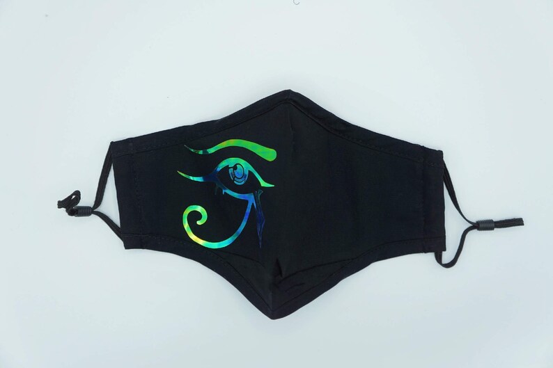 May include: Black face mask with a green, blue, and iridescent eye of Horus design.