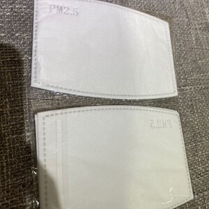 May include: Two white PM2.5 air filter replacements packaged in clear plastic.