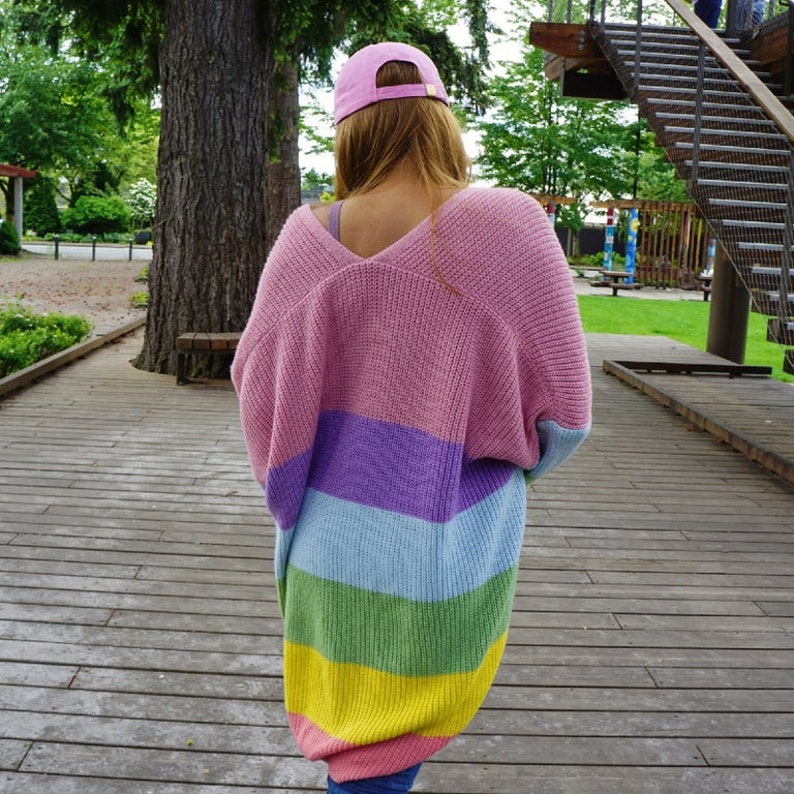 May include: A pink, purple, blue, green, and yellow striped cardigan with a V-neck.