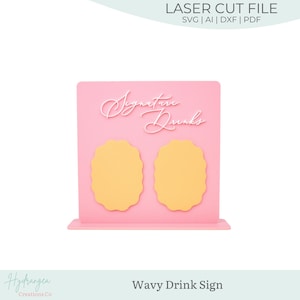 May include: A pink laser-cut sign with the words "Signature Drinks" in a cursive font. Two yellow, wavy-edged shapes are below the text. The sign is designed to stand upright. The words "LASER CUT FILE" are at the top.