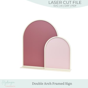 May include: A double arch framed sign with a light cream frame. The larger arch is filled with a mauve color, and the smaller arch is filled with a light pink color. The text "LASER CUT FILE" is at the top.