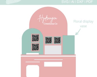 May include: A pink and green business card holder with a square reader slot, two QR code slots, and a floral display vase. The holder is labeled "Hydrangea Creations Co."
