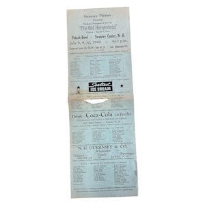 May include: A vintage playbill for "The Old Homestead" by the Swanzey Players, featuring a list of actors and sponsors. The playbill includes the date, time, and location of the performance, with text in black ink on a light blue background.