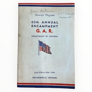 May include: A vintage souvenir program cover with red, white, and blue accents. The cover features the text "65th Annual Encampment G.A.R. Department of Indiana" and an American flag illustration. The program is dated June 25th to 29th, 1944, in Indianapolis, Indiana.