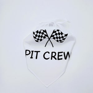 May include: White bandana with a black checkered flag design and the text "PIT CREW" printed on it.