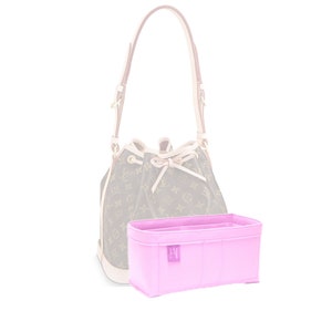 May include: A pink felt bag organiser with multiple compartments and a small logo. The organiser is designed to fit inside a luxury handbag.