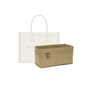May include: A beige felt bag organiser with multiple compartments and a logo. The organiser is designed to fit inside a white tote bag with the word "RIVIERA" printed on the side.