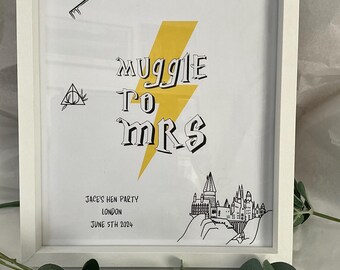 May include: A white framed print with a yellow lightning bolt and the text "Muggle to Mrs". The print also features a black and white illustration of Hogwarts castle and the text "Jace's Hen Party London June 5th 2024".