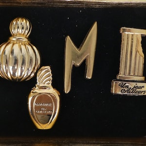 Collection of Luxury PERFUME Pins. Givenchy Amarige, Montana Parums, Un Jour Ailleurs, Wella. Four Goldtone Brooch Lapel Pins.