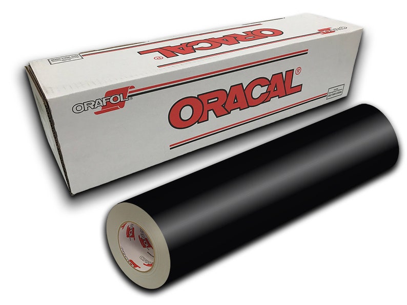 May include: A roll of black Oracal vinyl adhesive film in a white box with red lettering. The box has the brand name "Oracal" printed on it.