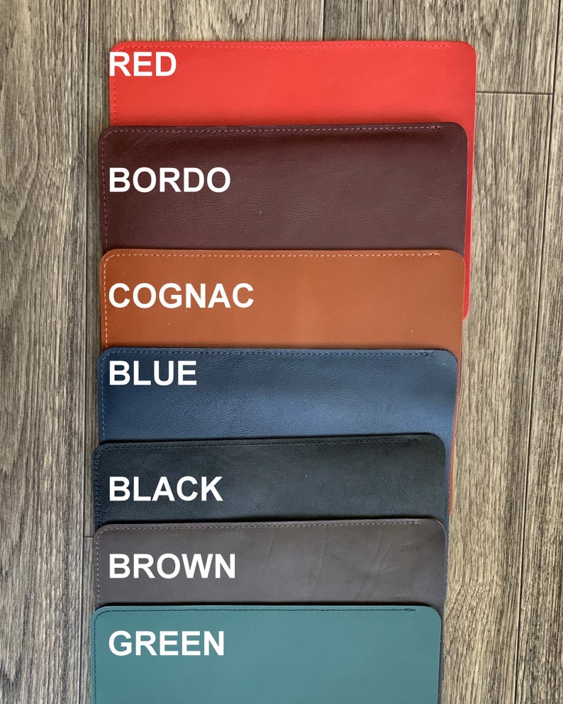 May include: Seven leather swatches in different colors: red, bordo, cognac, blue, black, brown, and green. The swatches are arranged vertically, with the red swatch at the top and the green swatch at the bottom.