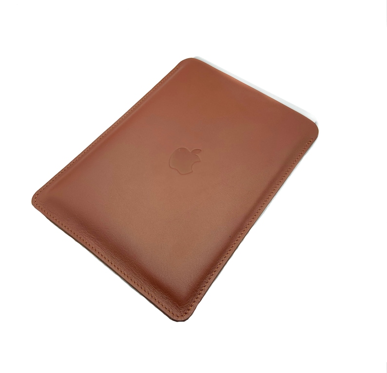 May include: A brown leather sleeve with a stitched edge and an embossed Apple logo.