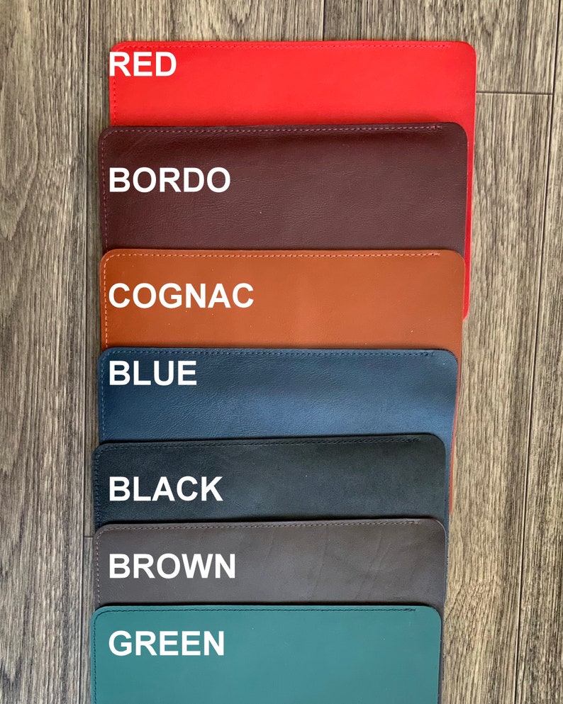 May include: Seven leather swatches in different colors: red, bordo, cognac, blue, black, brown, and green. Each swatch has a white text label with the color name.
