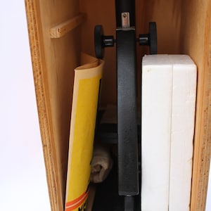 May include: A black microscope with a wooden storage case. The microscope has two knobs on the side and a white foam insert in the case.