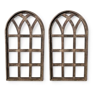 May include: Two decorative wooden window frames with arched tops and a grid pattern. The frames are made of weathered brown wood, creating a rustic aesthetic. The windows are empty, with a white background visible through the grid.