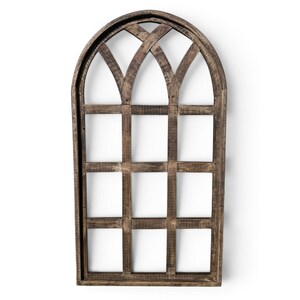 May include: A decorative wooden window frame with an arched top and a grid pattern. The frame is made of weathered brown wood, and the grid sections are open, revealing a white background. This rustic wall decor adds a farmhouse touch.