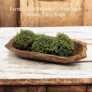 May include: Three green mossy twig balls in a brown farmhouse style wooden bowl. Farmhouse Brown + 3 Five Inch Mossy Twig Balls.