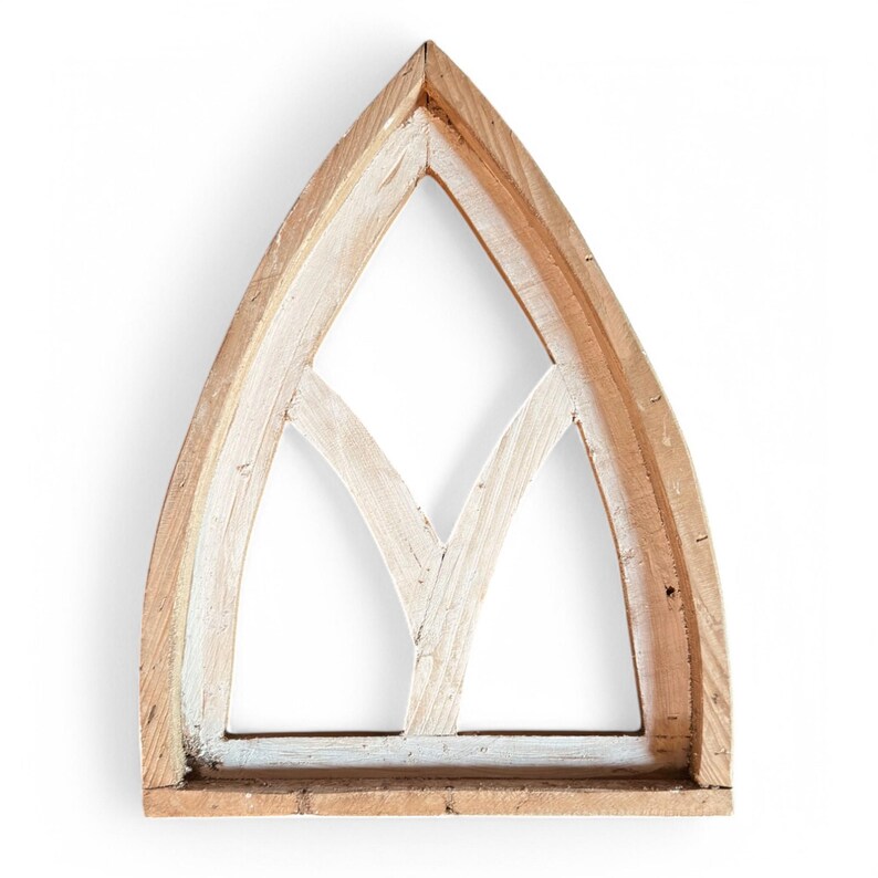 May include: A wooden arched window frame with a white painted finish and a decorative lattice design. The frame is made of natural wood with a rustic look.