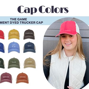 May include: A selection of pigment dyed trucker caps in various colours, including red, mustard, charcoal, royal blue, sky blue, navy, bottle green, olive, khaki, maroon, and orange. The caps are all made of a soft, comfortable material and feature a mesh back.