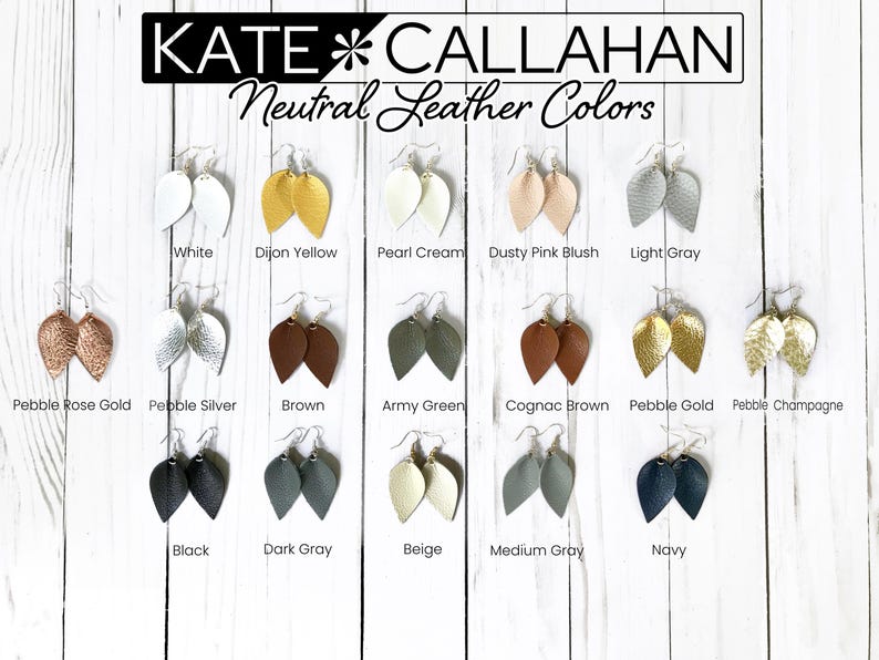 May include: A variety of leather earrings in different colors and textures, including white, yellow, cream, pink, gray, brown, green, gold, and champagne. The earrings are arranged in rows on a white wooden surface. The text "KATE CALLAHAN Neutral Leather Colors" is displayed at the top of the image.