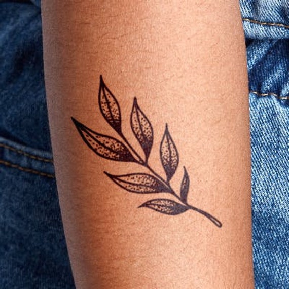 Maple leaf tattoo design on a man's arm on Craiyon