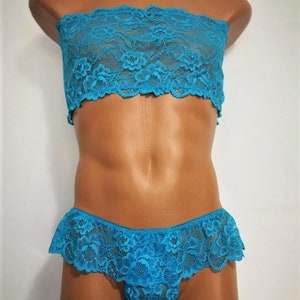 May include: A turquoise lace bandeau top and matching lace panty set. The set features a delicate floral pattern and a ruffled trim.
